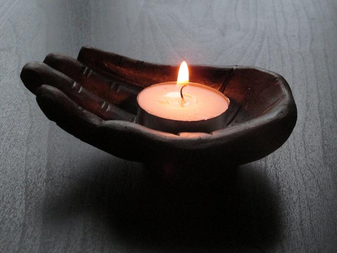 Umelá ruka, sviečka, symbol relaxu a masáže